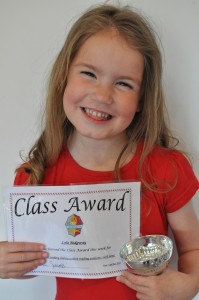 Day 436: Lola came home from school with the Class Award trophy and certificate for her reading. She was so proud!